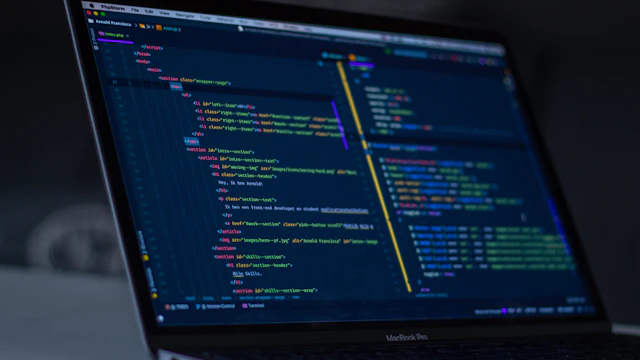 Developer writing code on a laptop